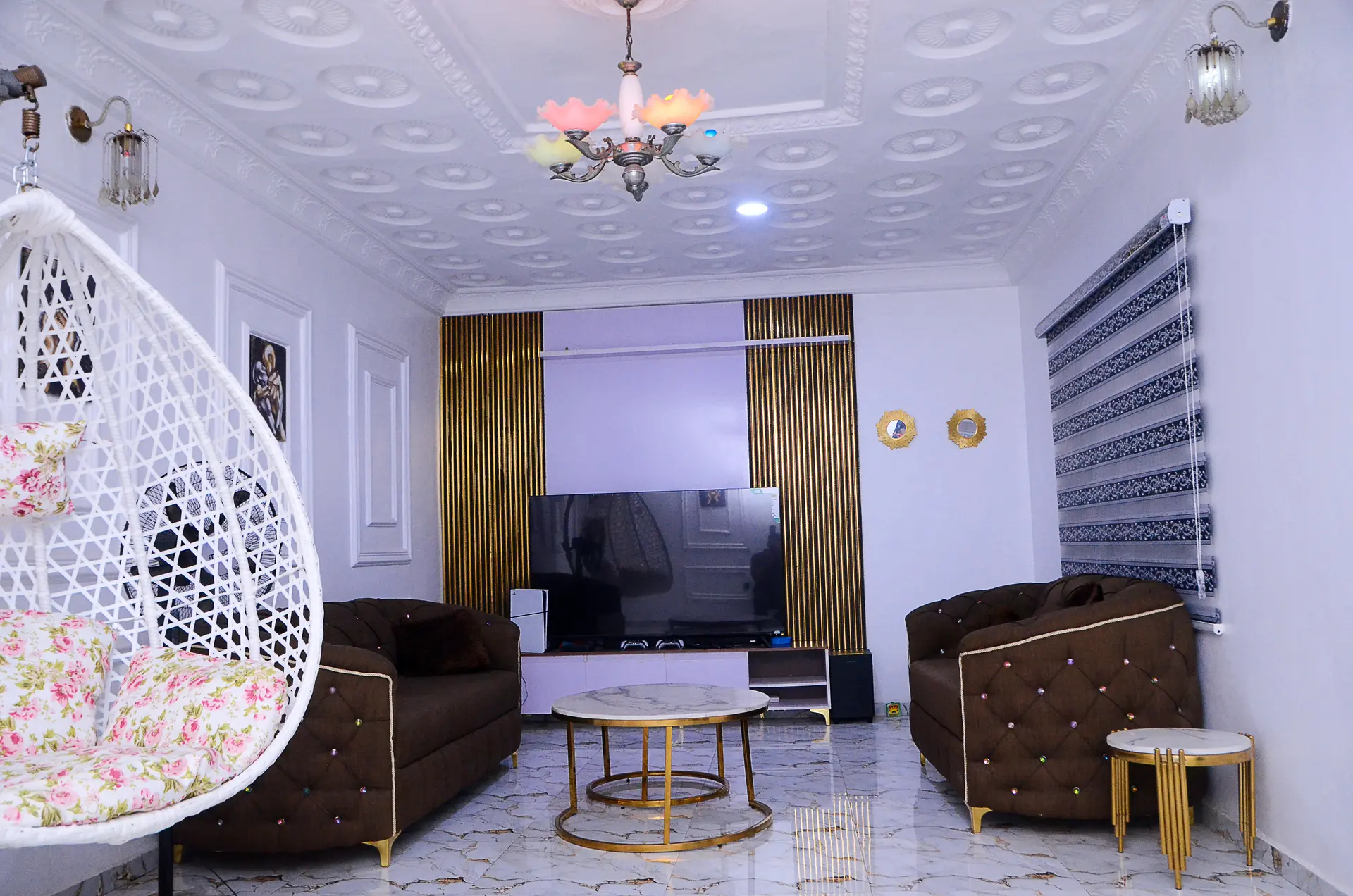 Elegant living room with hanging chair and lounge seating in Ibadan